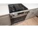 Stainless steel gas range with flat top griddle and modern knobs in a bright and airy kitchen at 215 Purslane Dr, Franklinton, NC 27525