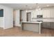 Open-concept kitchen featuring a large island, pendant lighting, and modern appliances at 215 Purslane Dr, Franklinton, NC 27525