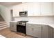 Kitchen with modern appliances, white countertops, and gray cabinets offer sleek style and functionality at 215 Purslane Dr, Franklinton, NC 27525
