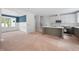 Open-concept kitchen and dining area with white cabinetry, an island with a gray base, and large windows at 215 Purslane Dr, Franklinton, NC 27525