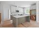 Spacious kitchen with gray and white cabinets, a center island, stainless steel appliances, and ample counter space at 215 Purslane Dr, Franklinton, NC 27525