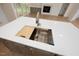 Kitchen island with sink features a built-in cutting board and stainless steel drying rack at 215 Purslane Dr, Franklinton, NC 27525