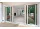 Bright living room featuring an elegant fireplace, sliding glass doors, and a view of the wooded backyard at 215 Purslane Dr, Franklinton, NC 27525
