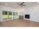 Bright living room featuring a fireplace, built-in shelving, sliding glass doors, and ceiling fan at 215 Purslane Dr, Franklinton, NC 27525