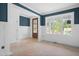 Unfinished room with a large window, wainscoting and a door with glass panels at 215 Purslane Dr, Franklinton, NC 27525