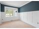 Unfinished room with a large window and wainscoting beneath a dark-blue wall at 215 Purslane Dr, Franklinton, NC 27525