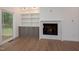 Living room with a fireplace and built-in shelving provides both style and functionality at 215 Purslane Dr, Franklinton, NC 27525