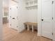 Functional mudroom with built-in bench, storage cubbies, coat hooks, and plank flooring at 215 Purslane Dr, Franklinton, NC 27525