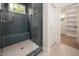 Modern shower featuring blue hexagonal tile, glass enclosure, and built-in bench at 215 Purslane Dr, Franklinton, NC 27525