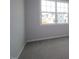 Bright bedroom with a large window offering neighborhood views and soft neutral carpeting, creating a serene space at 2454 Englemann Dr # 380, New Hill, NC 27562
