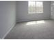 Inviting bedroom with neutral carpeting, light-filled windows, and walls painted in a relaxing neutral color at 2454 Englemann Dr # 380, New Hill, NC 27562
