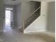 View of Entryway featuring staircase, door to outside and unfinished floors at 2454 Englemann Dr # 380, New Hill, NC 27562