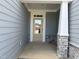 Inviting front porch with stone accents and a classic front door with glass panes at 2454 Englemann Dr # 380, New Hill, NC 27562