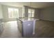 Modern kitchen features light gray cabinetry, stainless steel dishwasher, quartz countertops, and an open-concept design at 2454 Englemann Dr # 380, New Hill, NC 27562