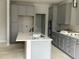 Modern kitchen boasts gray cabinets, white countertops, stainless steel appliances, and a stylish tile backsplash at 2454 Englemann Dr # 380, New Hill, NC 27562