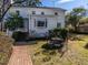 Spacious backyard with brick path, outdoor seating area, and lush greenery surrounding the home at 2521 St Mary'S St, Raleigh, NC 27609