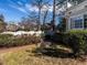 Relaxing backyard setting with wrought iron furniture surrounded by green space and a white fence at 2521 St Mary'S St, Raleigh, NC 27609