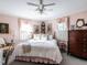 Cozy bedroom featuring soft pink walls, plush bedding, and natural light from shuttered windows at 2521 St Mary'S St, Raleigh, NC 27609