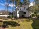 Back exterior showcasing the home's architecture, complemented by a well-maintained lawn and mature trees at 2521 St Mary'S St, Raleigh, NC 27609