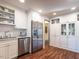 Spacious kitchen with white cabinets, stainless steel appliances, and beautiful wood floors at 2521 St Mary'S St, Raleigh, NC 27609