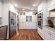 Bright kitchen featuring white cabinets, stainless appliances, and stunning hardwood flooring at 2521 St Mary'S St, Raleigh, NC 27609