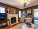 Inviting living room with a fireplace, wood paneling and a classic chandelier at 2521 St Mary'S St, Raleigh, NC 27609