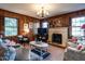 Cozy living room with wood-paneled walls, fireplace, and comfortable seating at 2521 St Mary'S St, Raleigh, NC 27609