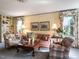 Bright living room featuring built-in shelves, plush seating, and large windows at 2521 St Mary'S St, Raleigh, NC 27609