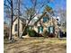 Charming brick home with green shutters and mature trees in a well-maintained yard at 300 Barthel Dr, Cary, NC 27513