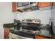 Close-up of modern range with stainless steel appliances and dark countertops, showcasing functionality and style at 301 Fayettville St # 2908, Raleigh, NC 27601