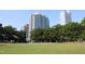 Scenic park view with lush green grass and trees framing impressive high-rise buildings in the distance at 301 Fayettville St # 2908, Raleigh, NC 27601