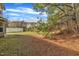 The backyard of the home with an unfinished patio area and pine needles at 3100 Cynthiana Ct, Raleigh, NC 27610