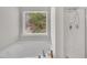Bright bathroom featuring a soaking tub beneath a window and a separate shower at 3100 Cynthiana Ct, Raleigh, NC 27610