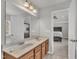 Bright bathroom featuring a double sink vanity, a large mirror, and access to the main bedroom at 3100 Cynthiana Ct, Raleigh, NC 27610