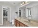 Bathroom with a double sink vanity, white toilet, walk-in closet, and natural light at 3100 Cynthiana Ct, Raleigh, NC 27610