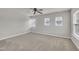 Inviting bedroom with three windows providing ample natural light, and plush carpet at 3100 Cynthiana Ct, Raleigh, NC 27610