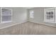 Bright, neutral bedroom featuring carpet and three windows offering plenty of light at 3100 Cynthiana Ct, Raleigh, NC 27610