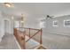 Bright upstairs hallway featuring a wooden banister and inviting carpeted floors at 3100 Cynthiana Ct, Raleigh, NC 27610