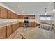 Functional kitchen with wooden cabinets, sleek appliances, and ample counter space for cooking prep at 3100 Cynthiana Ct, Raleigh, NC 27610