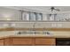 Modern kitchen sink area boasts sleek faucet, ample countertops, and wooden cabinets for storage at 3100 Cynthiana Ct, Raleigh, NC 27610