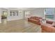 Bright living room featuring vinyl flooring, neutral wall paint, a sofa, a chandelier, and windows with decorative blinds at 3100 Cynthiana Ct, Raleigh, NC 27610