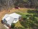 Aerial view of home, featuring a fenced in back yard, a storage shed and natural surrounding landscape at 3130 State Hwy 58, Louisburg, NC 27549