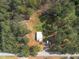 Aerial view of home surrounded by tall trees and natural landscape at 3130 State Hwy 58, Louisburg, NC 27549