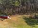 Picture of backyard storage shed with yard trailer and open grassy area at 3130 State Hwy 58, Louisburg, NC 27549