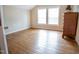 Bright bedroom featuring hardwood floors, a neutral color palette, and natural light from double windows at 3130 State Hwy 58, Louisburg, NC 27549