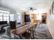 Open dining area with wood table, connecting to a kitchen with stainless steel appliances and wood cabinets at 3130 State Hwy 58, Louisburg, NC 27549