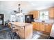 Open kitchen concept, breakfast bar with stools, wood cabinets and stainless steel appliances at 3130 State Hwy 58, Louisburg, NC 27549