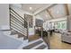 Modern staircase showcasing sleek metal railings and light wood steps leading to a open floorplan at 33 Henry Ct, Chapel Hill, NC 27516