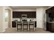 Well-equipped kitchen featuring dark cabinets, stainless steel appliances, granite counters, and a central island at 3725 Massey Pond Trl, Raleigh, NC 27616