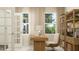 Light-filled home office features built in bookcase, modern desk and neutral decor for a productive workspace at 3725 Massey Pond Trl, Raleigh, NC 27616